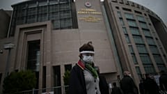 A lawyer arrives at the court in Istanbul Friday, Dec. 18, 2020 to attend the opening hearing of a new trial against jailed Turkish businessman, philanthropist Osman Kavala.