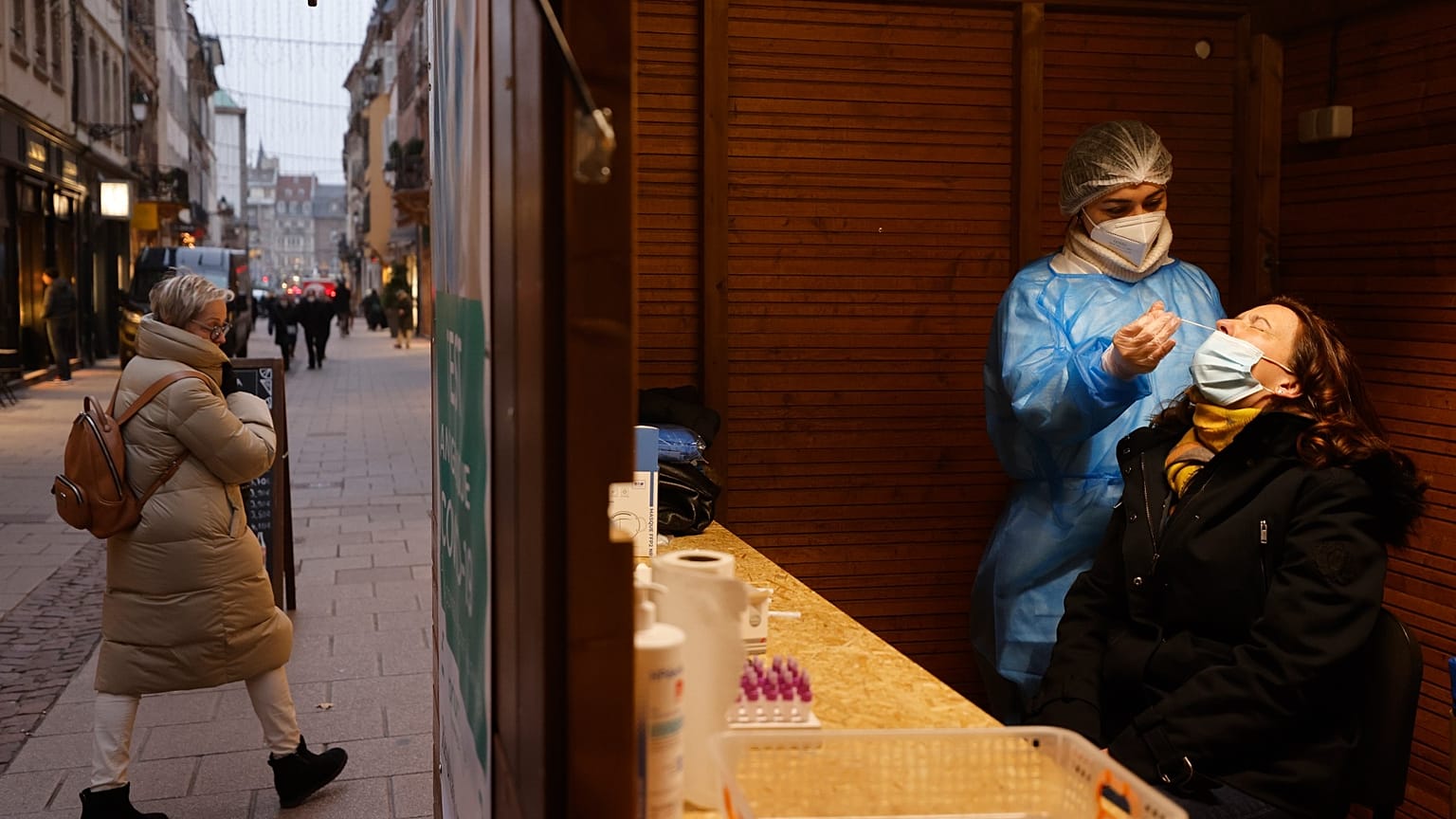 A woman has a transgenic test made at the Christmas market during its preparation in Strasbourg, eastern France, Nov. 25, 2021. 