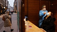 A woman has a transgenic test made at the Christmas market during its preparation in Strasbourg, eastern France, Nov. 25, 2021. 