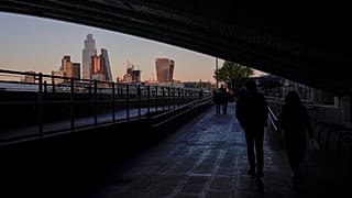 The skyline of the financial district known as The City, is seen as the sun sets in London, Nov. 23, 2021.