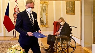 Czech President Milos Zeman, right, in a transparent cube because he tested positive to COVID-19, appoints ODS leader Petr Fiala, left, as Czech Prime Minister 