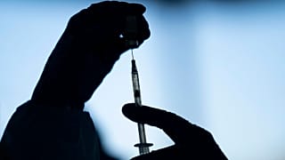 A medical staff member prepares the Pfizer-BioNTech COVID-19 vaccine at Tudor Ranch in Mecca, Calif. on Jan. 21, 2021.