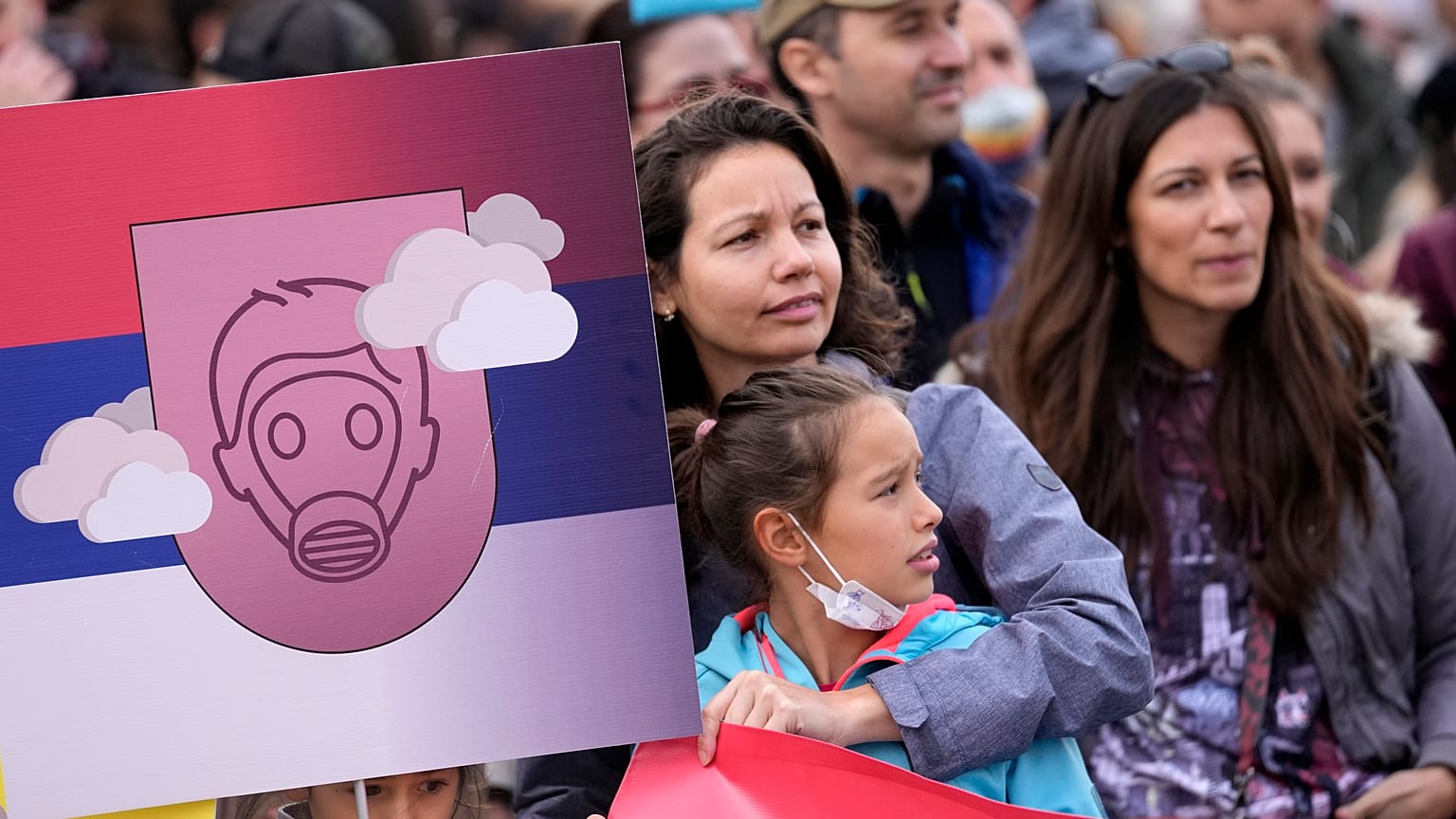 People march during a protest for clean air in Belgrade, Serbia, Sunday, Nov. 28, 2021.