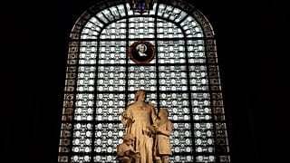 Statues representing Saint Jean Baptiste de La Salle are displayed in a Catholic Church in central Paris.