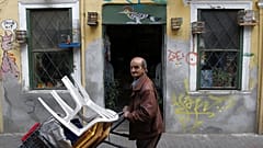 A street vendor pushes a trolley in Athens, Greece