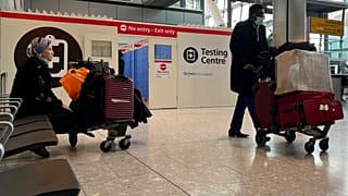Passengers get a COVID-19 test at a Testing Centre at Heathrow Airport in London.