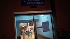 A worker wipes the floor by the pediatric emergency entrance at the Hospital Garcia de Orta in Almada, south of Lisbon, Tuesday, Nov. 30, 2021. 