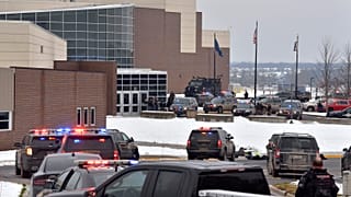 Dozens of police, fire, and EMS personnel work on the scene of a shooting at Oxford High School, Tuesday, Nov. 30, 2021, In Oxford Township, Mich.