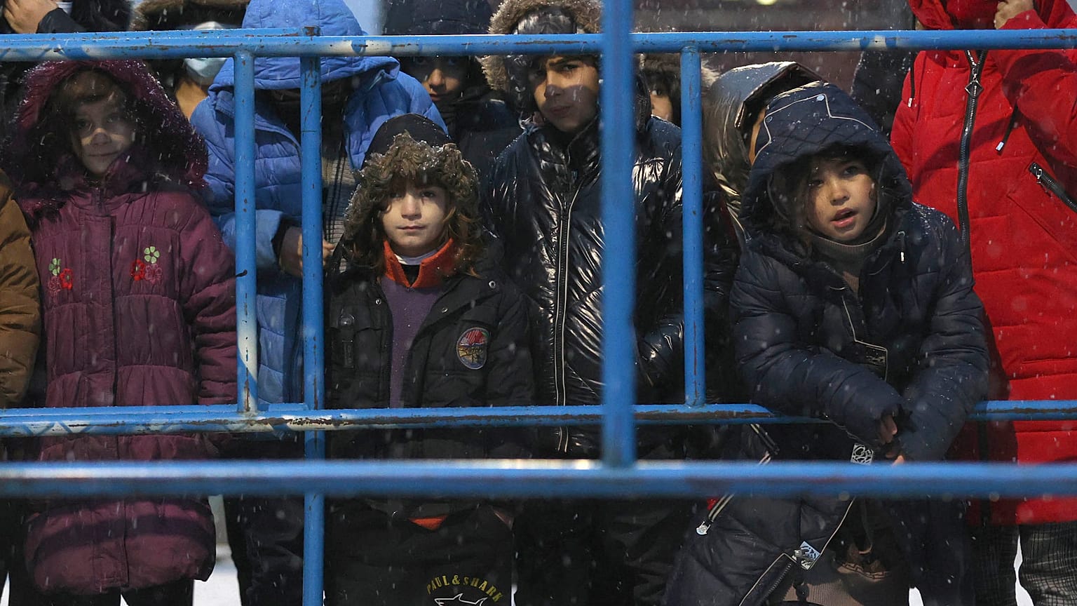 Migrants stands in queue to receive a hot food at a logistics center at the checkpoint logistics center "Bruzgi" at the Belarus-Poland border near Grodno