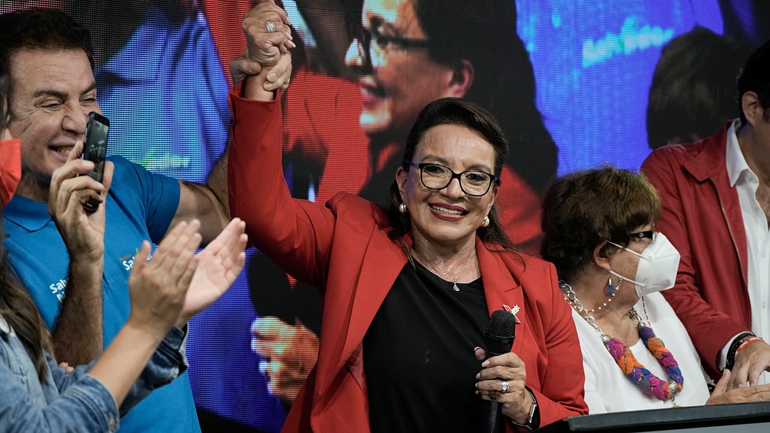 Free Party presidential candidate Xiomara Castro has her hand raised by her running mate Salvador Nasralla after general elections, in Tegucigalpa, Honduras.