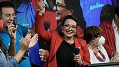 Free Party presidential candidate Xiomara Castro has her hand raised by her running mate Salvador Nasralla after general elections, in Tegucigalpa, Honduras.