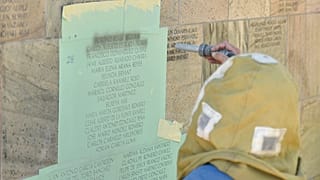 15 novembre 2021: l'incisore Randy Montgomery aggiunge nuovi nomi al Wall Las Memorias AIDS Monument a Lincoln Park, Los Angeles