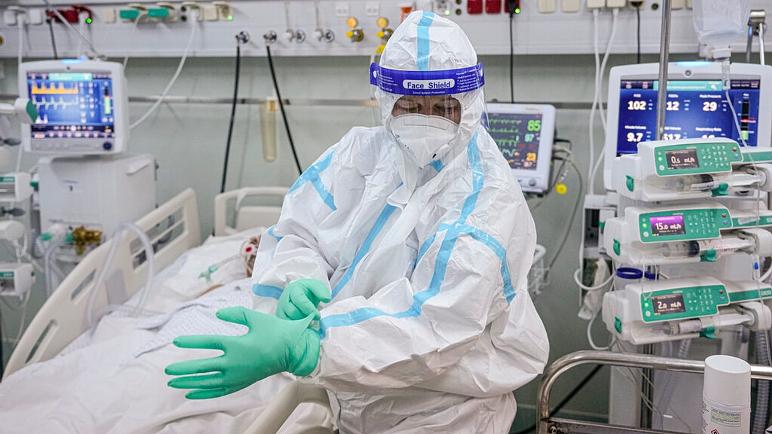 An ICU staff member puts on an extra pair of gloves in the COVID-19 ICU unit of Marius Nasta National Pneumology Institute in Bucharest, Romania, September 2021