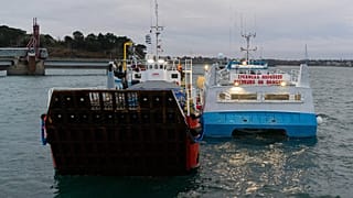 French fishing boats with Normandy Trader at left block the entrance to the port of Saint-Malo, western France, Friday, Nov. 26, 2021.
