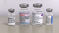 Vials of the COVID-19 vaccine by Moderna (C) and Pfizer / BioNTech against the novel coronavirus stand on a table in a vaccination center in Sonthofen, southern Germany.