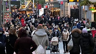 People wear mandatory face masks in a shopping street in Dortmund, Germany, Dec. 1, 2021