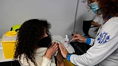 A woman receives a Pfizer COVID-19 vaccination in the Wizink Center in Madrid, Spain, Wednesday, Dec. 1, 2021.