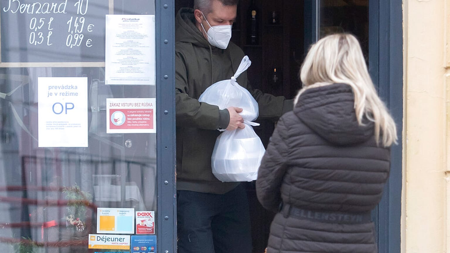A man leaves a shop in Bratislava, Slovakia, where the government approved a fresh two-week lockdown to combat rising COVID-19 cases in November
