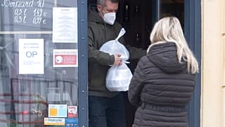 A man leaves a shop in Bratislava, Slovakia, where the government approved a fresh two-week lockdown to combat rising COVID-19 cases in November