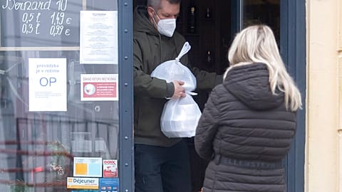 A man leaves a shop in Bratislava, Slovakia, where the government approved a fresh two-week lockdown to combat rising COVID-19 cases in November