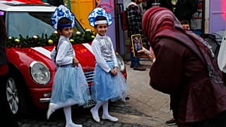 Dos niñas palestinas posan en el mercado navideño de Belén, Palestina 2/12/2021