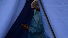 A healthcare worker waits to test people for 'COVID-19 at a facility in Soweto, South Africa, Wednesday Dec. 2, 2021. 