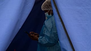 A healthcare worker waits to test people for 'COVID-19 at a facility in Soweto, South Africa, Wednesday Dec. 2, 2021. 