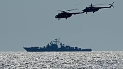 Ukrainian helicopters fly over a Russian warship during Ukraine-NATO Sea Breeze 2021 manoeuvres, in the Black Sea, Friday, July 9, 2021. 