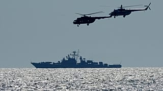 Ukrainian helicopters fly over a Russian warship during Ukraine-NATO Sea Breeze 2021 manoeuvres, in the Black Sea, Friday, July 9, 2021.