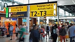 People walk through an airport