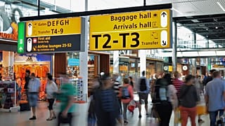 People walk through an airport
