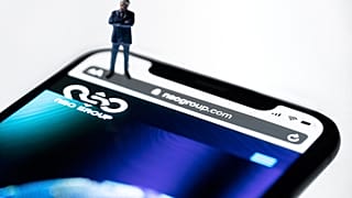 This studio photographic illustration shows a smartphone with the website of Israel's NSO Group which features 'Pegasus' spyware, on display in Paris on July 21, 2021.