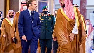 Saudi Crown Prince Mohammed bin Salman greets French President Emmanuel Macron upon his arrival in Jiddah, Saudi Arabia, Saturday, Dec. 4, 2021.