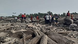 Rescuers and villagers in Candi Puro village on the island of East Java