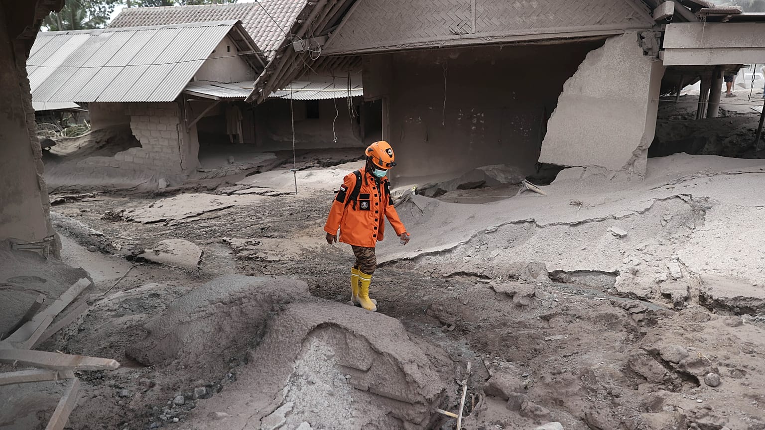 Un rescatista camina en una zona afectada por la erupción del volcán Semeru en el distrito de Lumajang, provincia de Java Oriental, Indonesia, el 5 de diciembre de 2021.