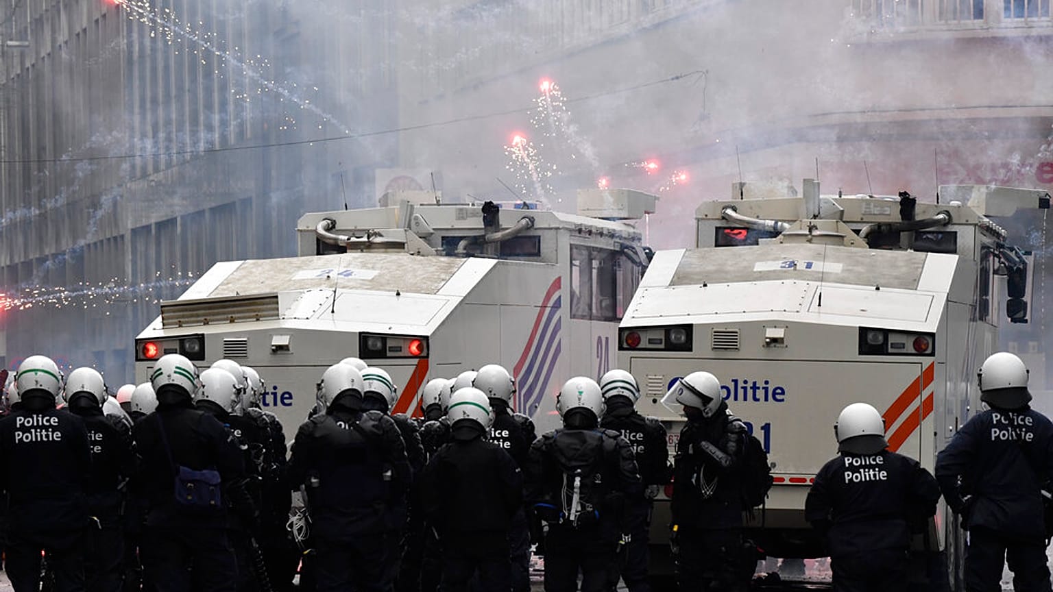 Demonstrators light fireworks during a protest against coronavirus measures in Brussels, Belgium, Sunday, Dec. 5, 2021.