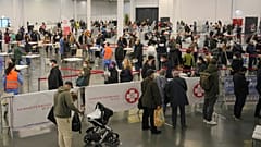 People wait in lines to register for COVID-19 vaccination  in Vienna, Austria