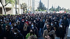 Protesters march during a rally in Athens, Greece, on Monday Dec. 6, 2021. 