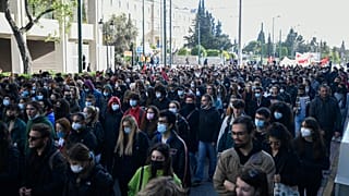 Protesters march during a rally in Athens, Greece, on Monday Dec. 6, 2021. 
