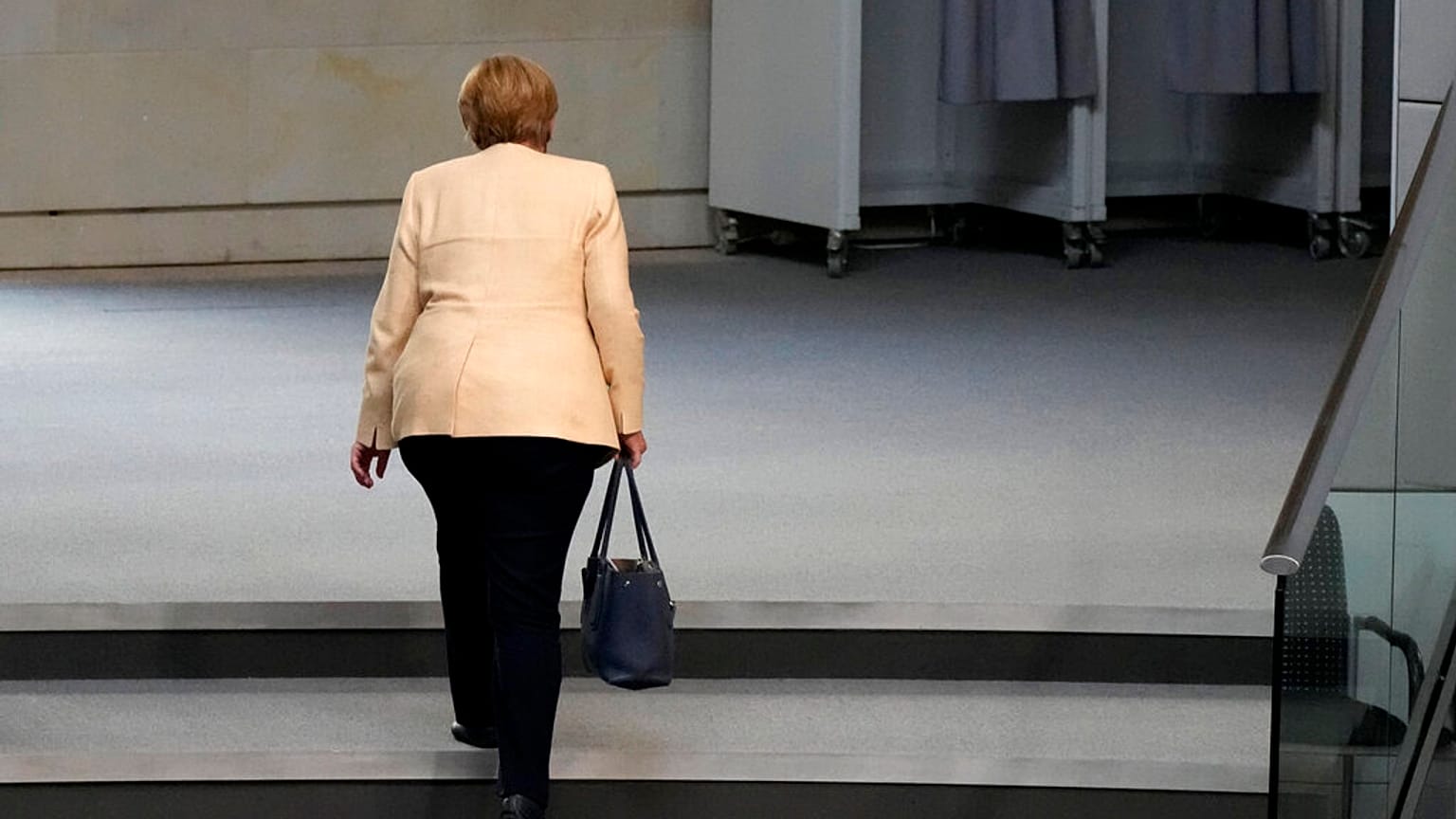 FILE - German Chancellor Angela Merkel leaves the plenary hall after a debate about the situation in Germany ahead of national elections in Berlin, Sept. 7, 2021. 