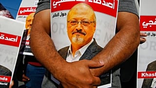 People hold posters of Jamal Khashoggi, near the Saudi Arabia consulate in Istanbul 