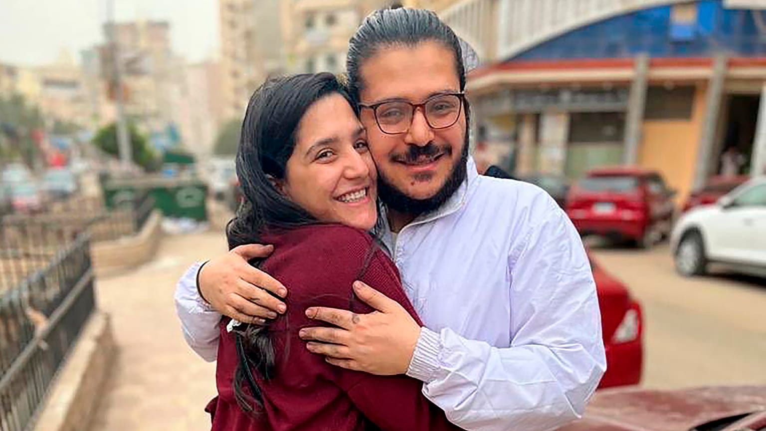 This handout image provided by Egyptian Initiative for Personal Rights (EIPR), shows rights activist Patrick George Zaki hugging his sister after his release, on Dec. 8, 2021.