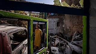 An Afghan citizen inspects the Ahmadi family house in Kabul, where 10 people including seven children were killed by an errant US drone strike in September 2021