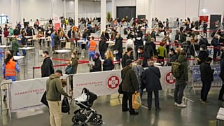 People wait in lines to register for COVID-19 vaccination on the second day of a national lockdown to combat soaring coronavirus infections, in Vienna, Austria, Nov. 23, 2021.