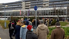 People queue to get the vaccinated against the COVID-19 virus in front of the Petz Aladar Hospital in Gyor, Hungary