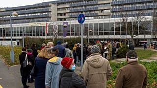 People queue to get the vaccinated against the COVID-19 virus in front of the Petz Aladar Hospital in Gyor, Hungary