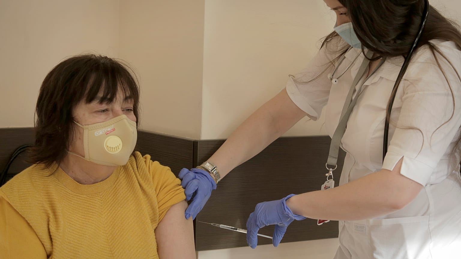 A medical worker administers a dose of the Oxford-AstraZeneca vaccine against COVID-19 in Sofia, Sunday, Feb. 7, 2021.
