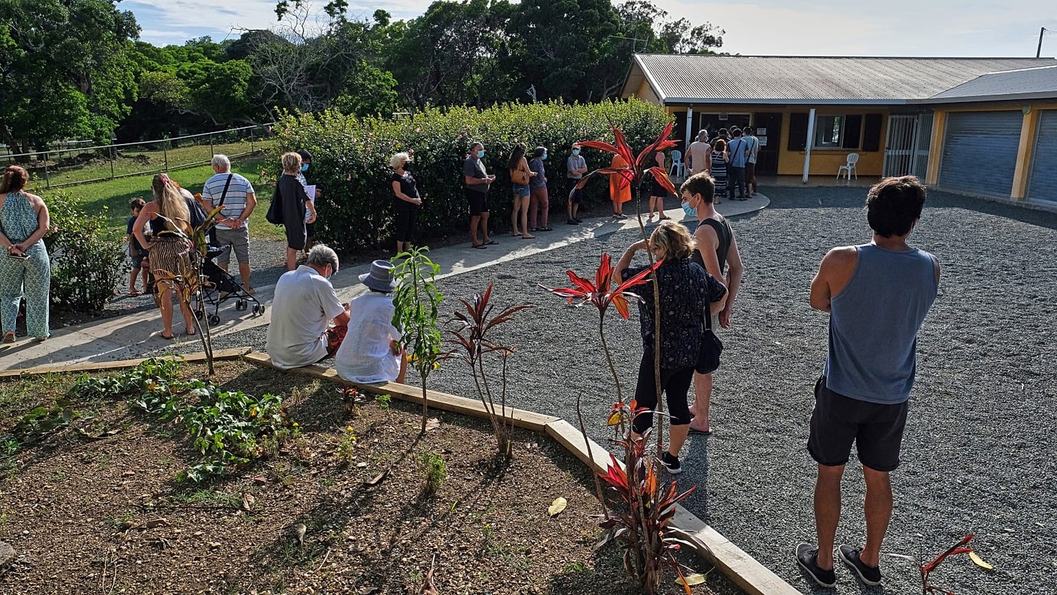 People queue outside a school to vote in a referendum in Noumea, New Caledonia, Sunday December 12, 2021