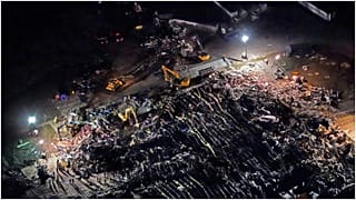 In this aerial photo, a collapsed factory is seen with workers searching for survivors, Saturday, Dec. 11, 2021, in Mayfield, Ky., after tornadoes came through the area the pr