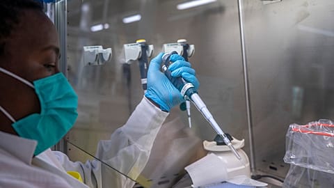 Puseletso Lesofi prepares to sequence COVID-19 omicron samples at the Ndlovu Research Centre in Elandsdoorn, South Africa, Dec. 8, 2021.